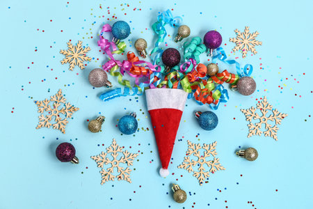 Composition with Santa hat, Christmas decorations and serpentine on color backgroundの写真素材