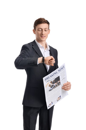 Young businessman with newspaper looking at wristwatch on white backgroundの写真素材