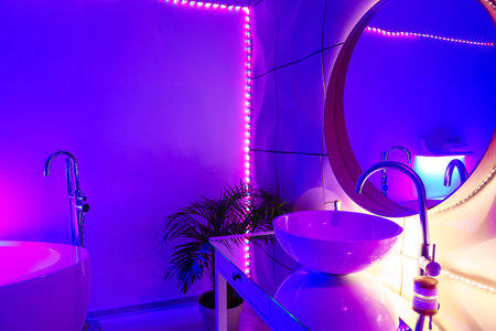 Interior of stylish bathroom with neon lightingの写真素材