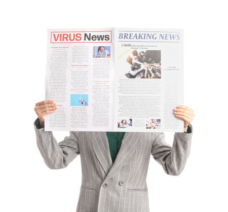 Young businesswoman reading newspaper on white backgroundの写真素材