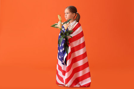 Little girl with USA flag and flowers on color background. memorial day celebrationの写真素材