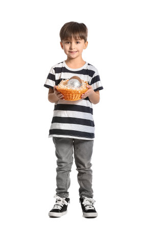 Cute little boy with basket of chocolate Easter eggs on white backgroundの写真素材