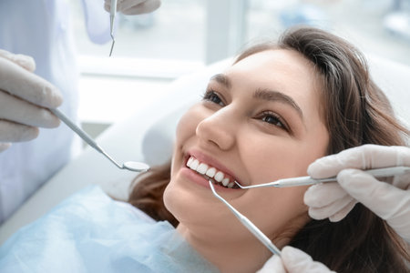 Young woman dentist visiting in clinic, closeupの写真素材