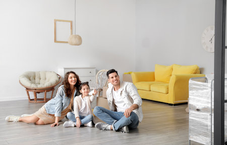 Happy family in their new house on moving dayの写真素材