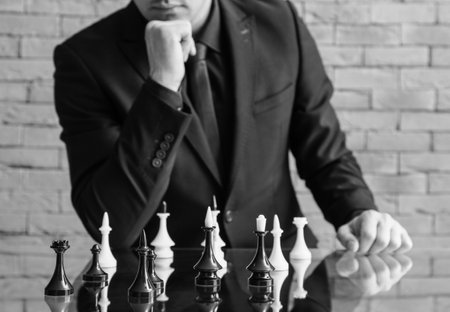 Man playing chess on glass table, closeupの写真素材