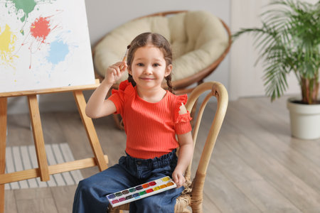 Cute little artist painting at home