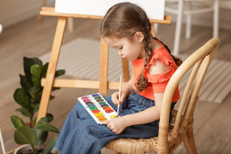 Cute little artist painting at homeの写真素材