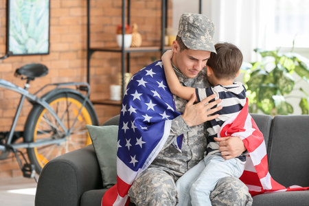 Soldier and his little son hugging at home. memorial day celebrationの写真素材