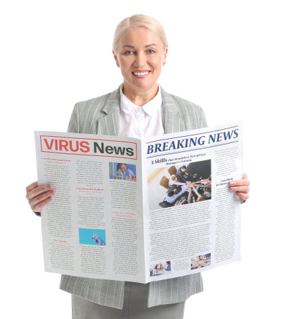 Mature businesswoman with newspaper on white backgroundの写真素材