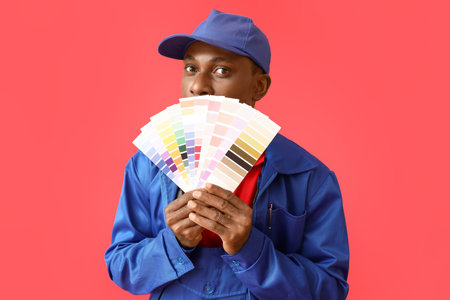 African-American decorator on color backgroundの写真素材