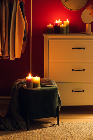 Interior of stylish dark room with burning candlesの写真素材