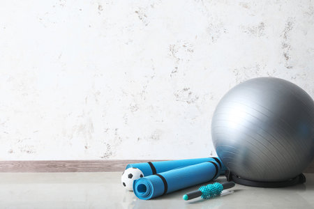 Different sports equipment near light wallの写真素材