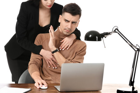 Beautiful young secretary seducing her boss on white background. concept of harassmentの写真素材