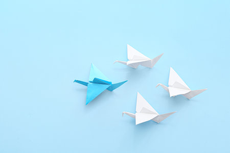 Origami cranes on color background. concept of uniquenessの写真素材