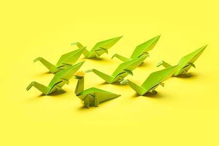 Origami dinosaurs on color background. concept of uniquenessの写真素材