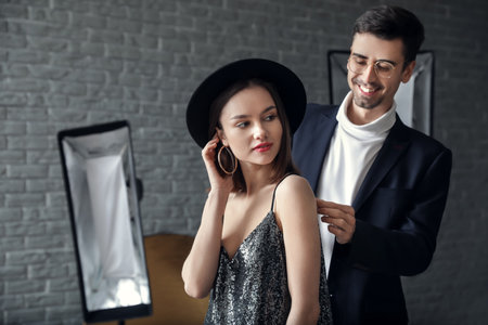 Male stylist working with model in studioの写真素材