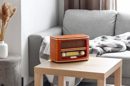 Retro radio receiver on table in living roomの写真素材