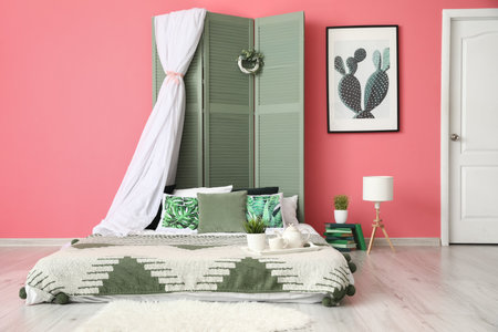 Interior of stylish bedroom with folding screenの写真素材