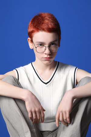 Non-binary teenager on color backgroundの写真素材