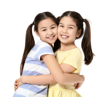 Cute Asian sisters on white backgroundの写真素材
