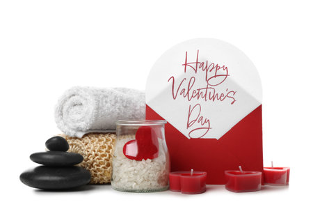 Letter with text HAPPY VALENTINE'S DAY and spa supplies on white backgroundの写真素材