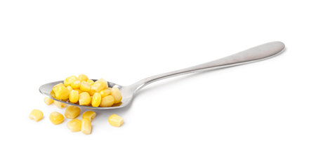 Spoon with canned corn isolated on white backgroundの写真素材