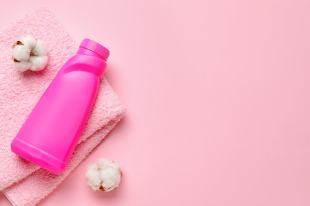 Laundry detergent, cotton flowers and towel on pink backgroundの写真素材