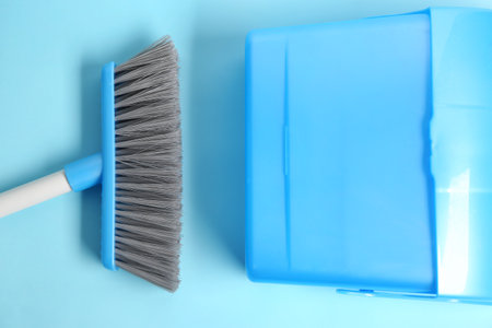 Dustpan and broom on color background, closeupの写真素材