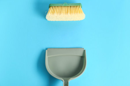 Dustpan with cleaning brush on color backgroundの写真素材