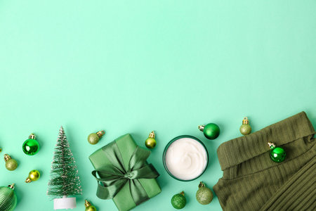 Jar of cream, Christmas gift, decorations and clothes on color backgroundの写真素材