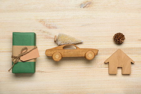 Christmas toy car with Christmas tree, decor and gift box on wooden backgroundの写真素材