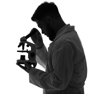 Silhouette of male scientist with microscope on white background