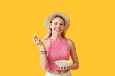 Beautiful young woman with tasty nachos on color backgroundの写真素材