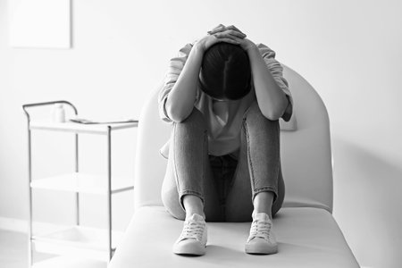 Black and white portrait of depressed young woman in clinicの写真素材