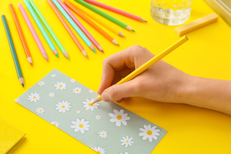 Woman coloring bookmark on color backgroundの写真素材