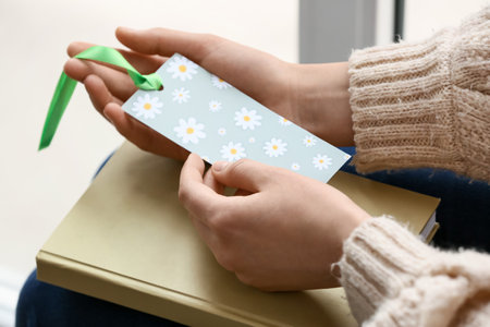 Woman with bookmark in room, closeupの写真素材