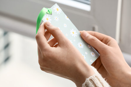 Woman with bookmark in room, closeupの写真素材