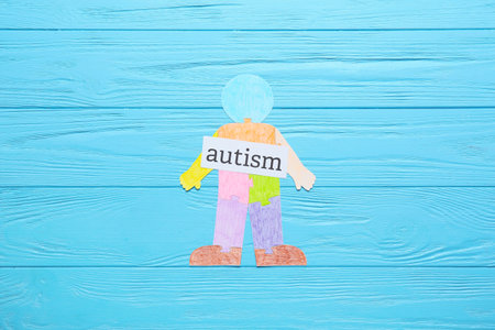 Colorful human figure and word AUTISM on color wooden backgroundの写真素材