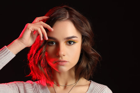 Beautiful young woman on dark backgroundの写真素材