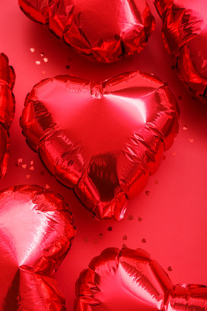 Heart-shaped balloons on red background. Valentine's Day celebrationの写真素材