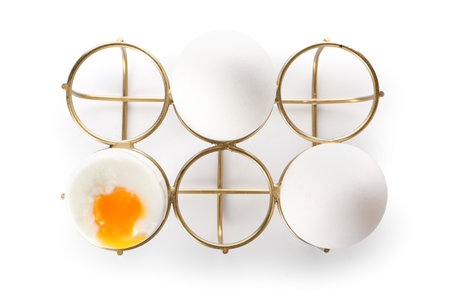Soft boiled eggs in holder on white backgroundの写真素材
