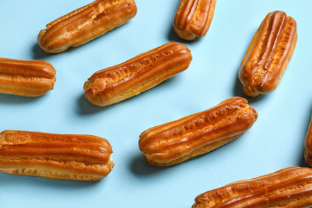 Many sweet eclairs on color backgroundの写真素材