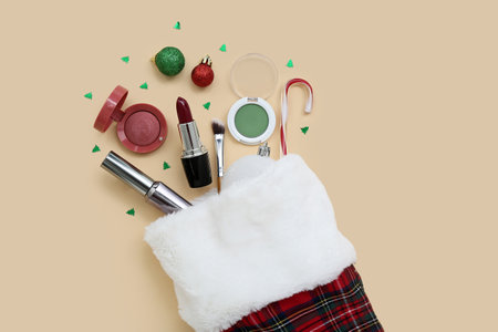Christmas sock with cosmetics and decorations on color backgroundの写真素材