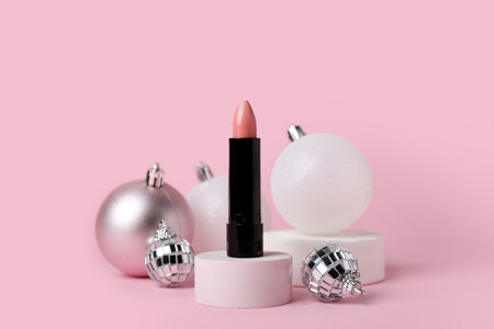 Composition with lipstick and Christmas balls on pink backgroundの写真素材