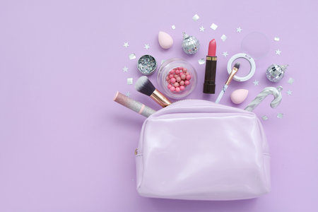 Composition with bag, decorative cosmetics and Christmas balls on lilac backgroundの写真素材