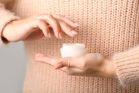 Woman holding jar of cream, closeupの写真素材