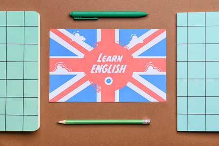 Stationery and UK flag on color background. Concept of learning Englishの写真素材