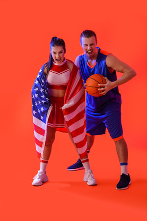Cheerleader and basketball player with USA flag on color backgroundの写真素材