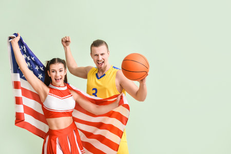 Cheerleader and basketball player with USA flag on color background
