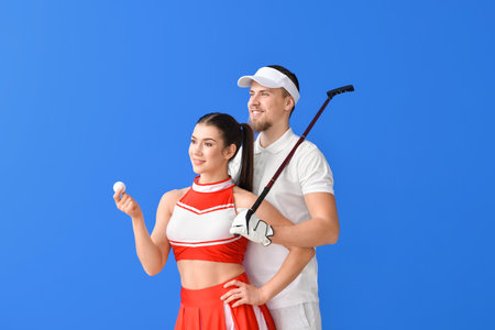 Cheerleader and golfer on color backgroundの写真素材